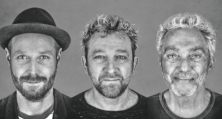 Greyscale portrait headshot photographs of Blicher Hemmer Gadd music group members - four-time Danish Grammy-winning saxophonist Michael Blicher, Hammond wizard Dan Hemmer, and drum legend Steve Gadd grinning as they all pose for a picture next to each other