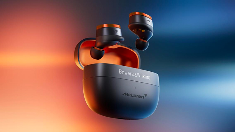 Bowers and Wilkins Pi8 McLaren Edition Wireless Earbuds floating in air above its open carrying case