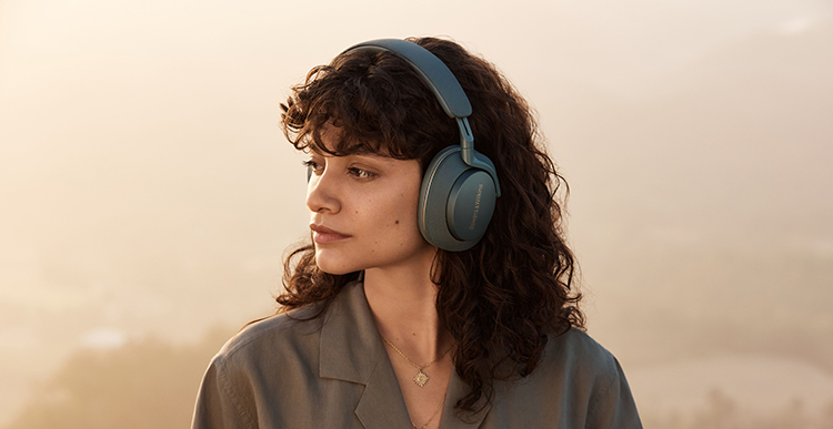 Woman facing away from the camera is wearing the Bowers and Wilkins Px7 S2e headphone (Forest Green finish)