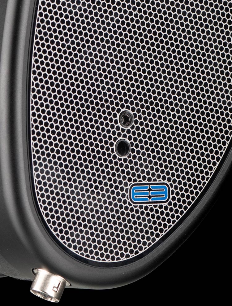 Close-up photograph perspective of the Dual-Mode Bass Port holes in the glass/outer earcup area of the Dan Clark Audio E3 Closed Back Headphone