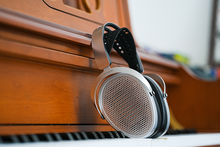 HIFIMAN Edition XV open-back planar headphone Side Angle View positioned on top of a piano