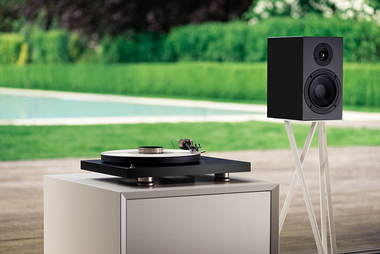 Pro-Ject Debut Pro B Turntable with a subwoofer mounted on a stand Angle View