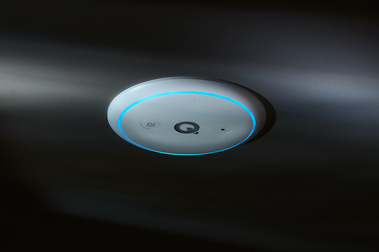 Q Acoustics E300A ceiling-installed hi-fi amplifier activated with Amazon Alexa voice recognition light indicator on as this product model is situated in a dark environment