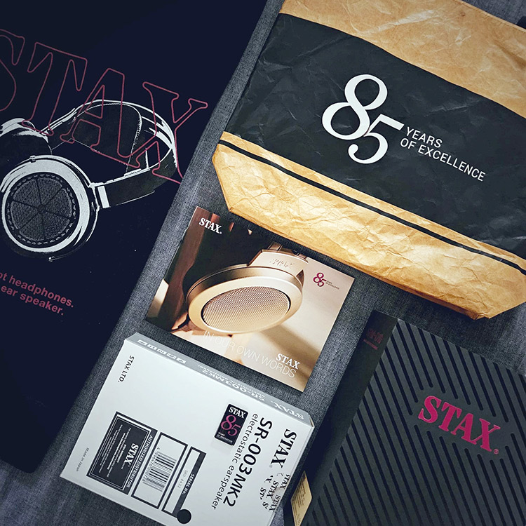 Right Angle View of STAX - 85 Years of Excellence special bundle containing several items such as a sweatshirt, bag, ebook, and two product giveaways