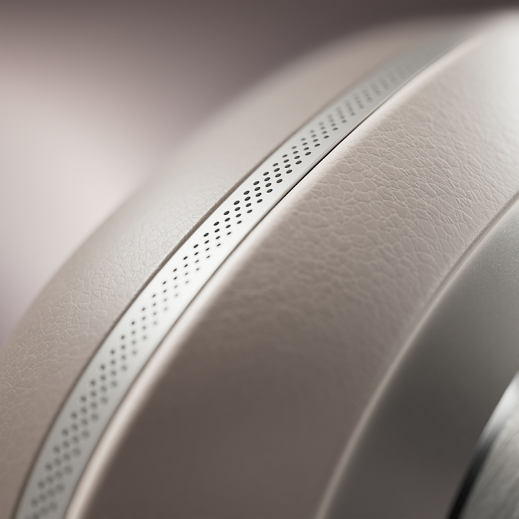 A highly detailed portrait orientation photograph marketing promotional image display close-up shot of the Bowers and Wilkins Px8 S2 Warm Stone color finish over-ear wireless headphones ear cup material