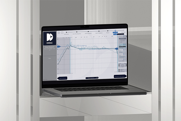 A laptop computer screen displays the Dirac Live software interface, showing graphs and controls for audio correction