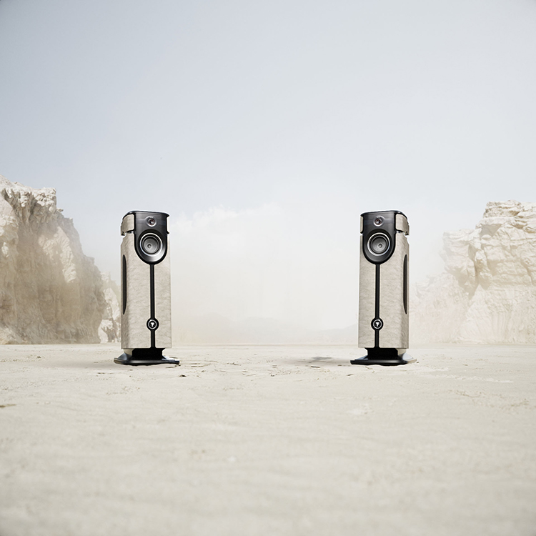 Digital portrait orientation promotional image display of the Focal Diva Mezza Utopia floorstanding active loudspeakers situated within a desert biome setting