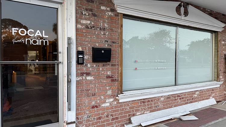 Landscape outdoor photograph of the Focal Powered by Naim Tampa location exterior entrance door and windows