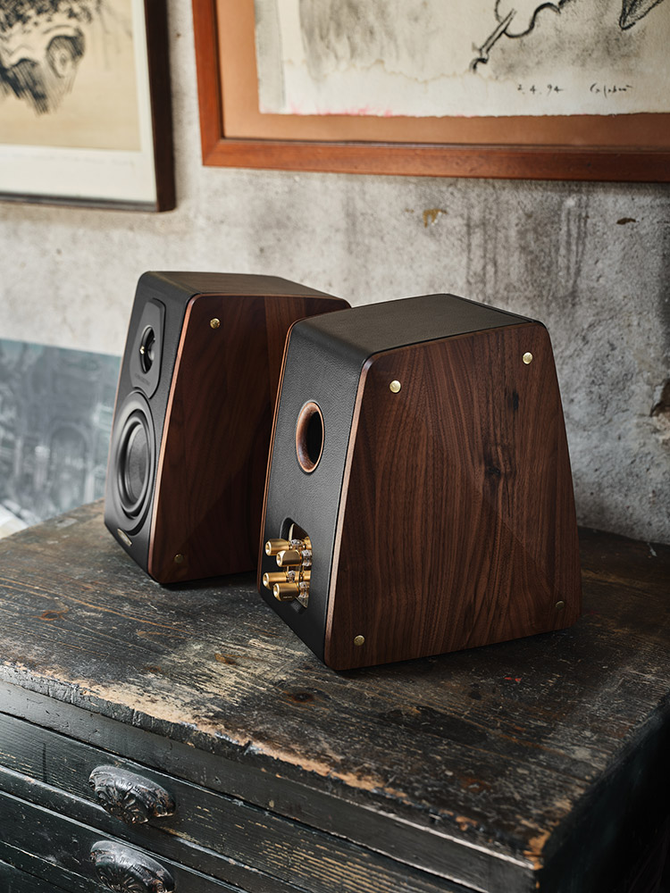 Sonus faber Concertino Maestro Edition Bookshelf Speakers Front Angle & Rear Angle View located on top of a tabletop