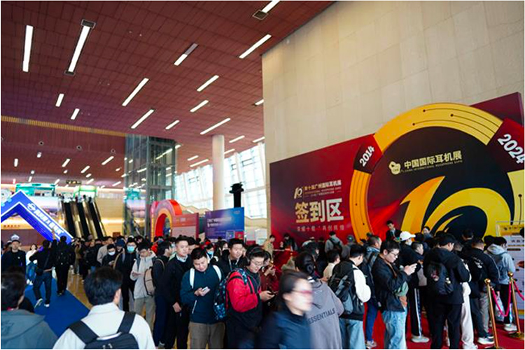 Portrait indoor photograph of the public waiting around in line and walking within the 2024 Guangzhou International Headphones Expo at the Baiyun International Convention Center in Guangzhou, China