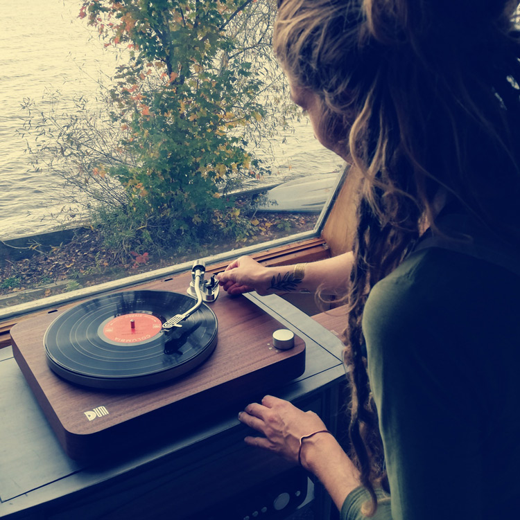 Woman setting up music record on Dum Audio Turntable