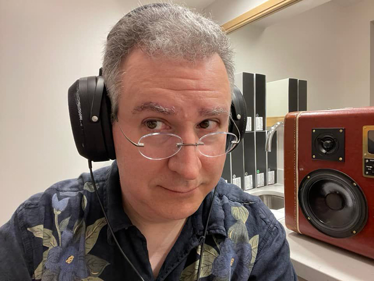 Selfie photograph of Carlo Lo Rasso listening through a German brand T+A product
