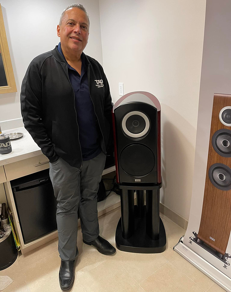 Dave Malekpour stands next to a TAD product at Florida Audio Expo 2022