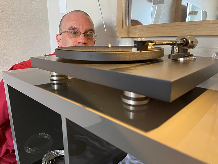 Picture taken of Chris Eberle while a Pro-Ject Audio Systems product is in the front foreground at the Florida Audio Expo 2022