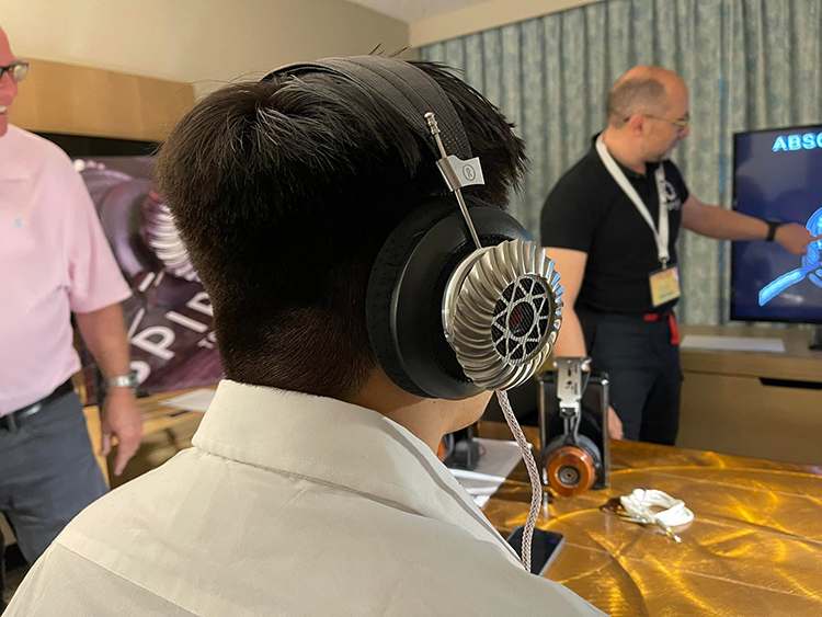 An individual tests the listening aspect of Studio Torino headphone at Florida Audio Expo 2022
