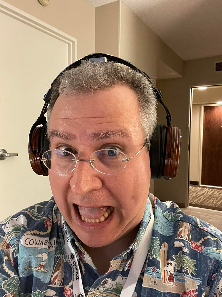 A photograph of Carlo Lo Rasso ecstatic about the listening quality of Studio Torino headphone at Florida Audio Expo 2022