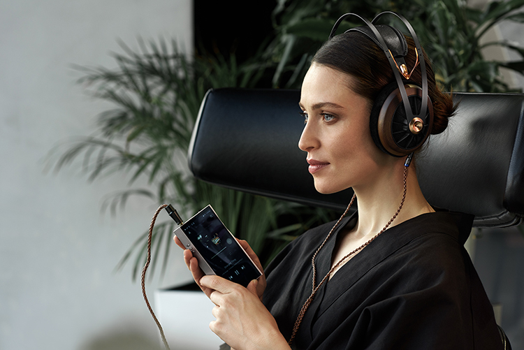 A woman listens to music utilizing the Meze Audio 109 PRO Dynamic Open-Back Headphone